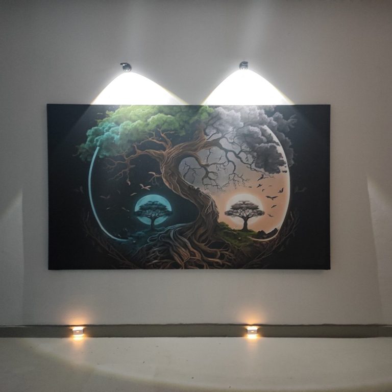 Wandbild mit Yin-Yang-Symbol, Bäume in Blau und Grün, beleuchtet von zwei Deckenstrahlern.